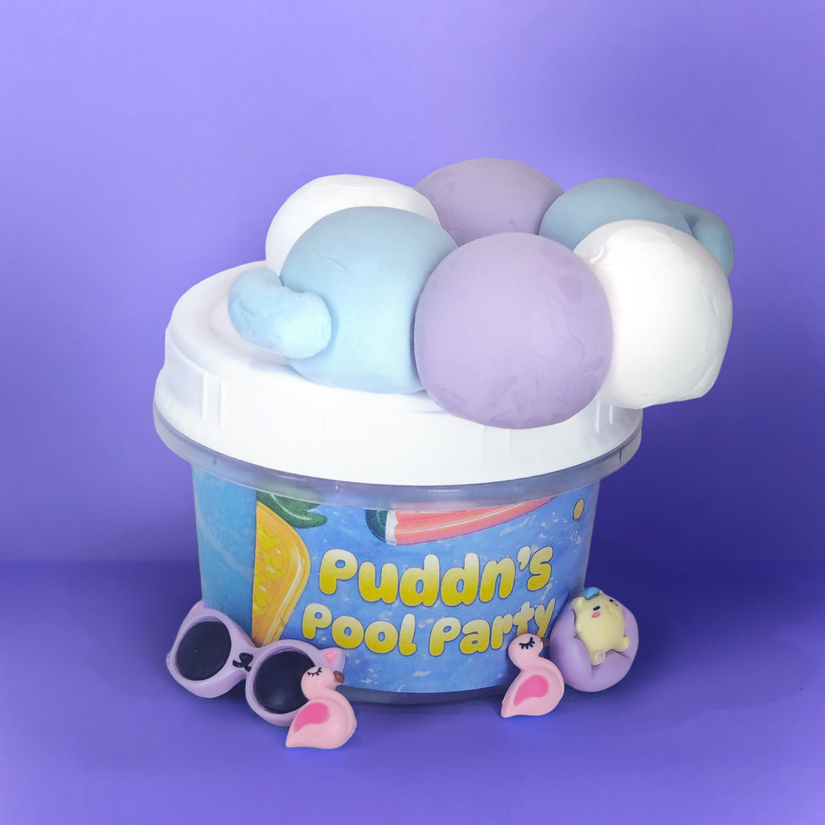 A clear plastic tub labeled 'Puddn's Pool Party' filled with pastel pool slime, topped with a white lid. The slime includes light blue, lavender purple, and white pieces.